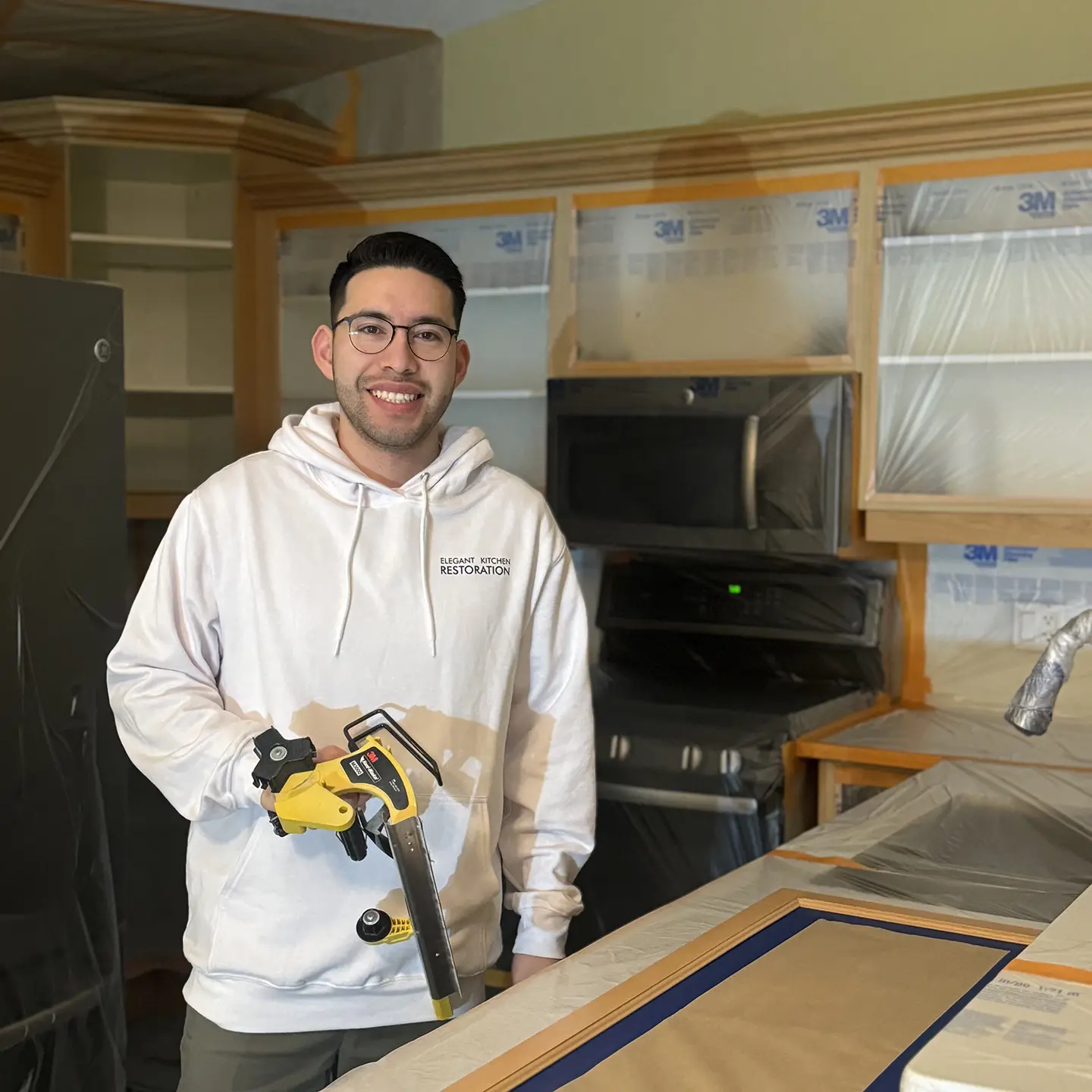 Helaman Hernandez of Elegant Kitchen Restoration preparing for cabinet refinishing in London Ontario